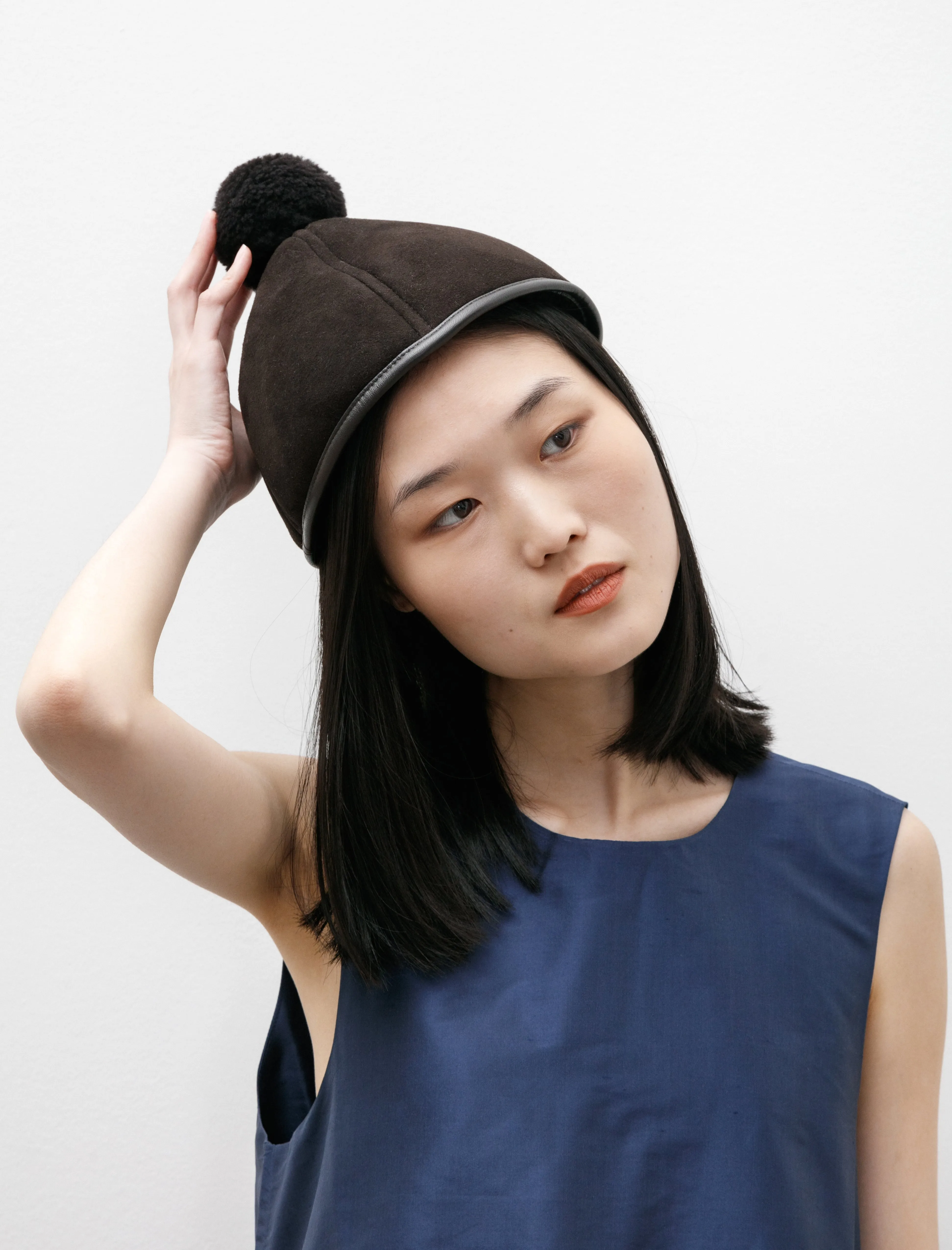 Suede Back Curly Shell Hat with Pompom